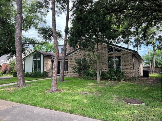 view of front of house featuring central AC and a front lawn