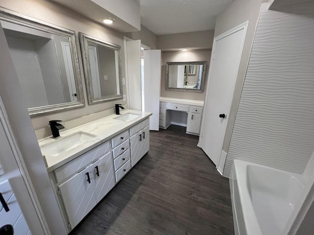 bathroom with vanity, a textured ceiling, and hardwood / wood-style flooring