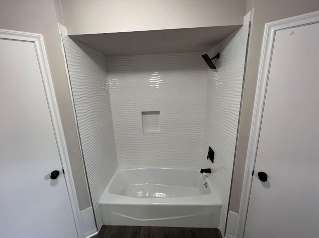 bathroom with hardwood / wood-style floors and  shower combination