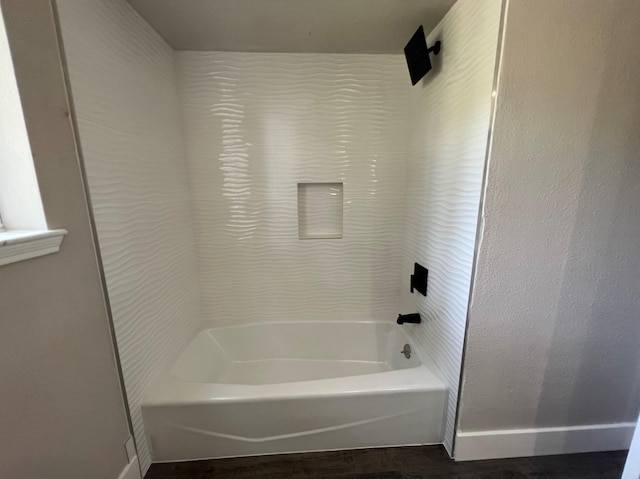 bathroom featuring shower / bathtub combination and hardwood / wood-style flooring