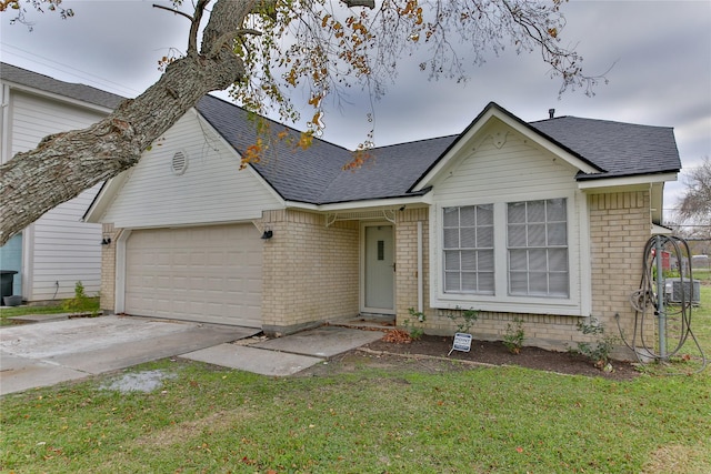 ranch-style house featuring a front lawn and a garage