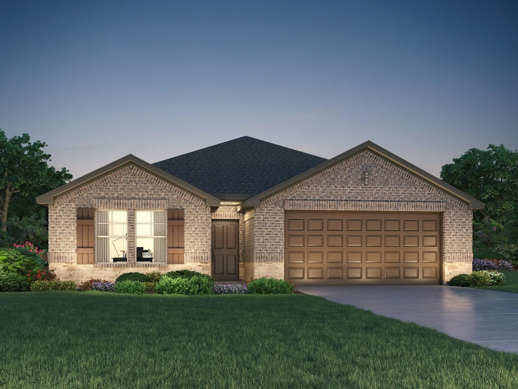 view of front facade with a garage and a lawn