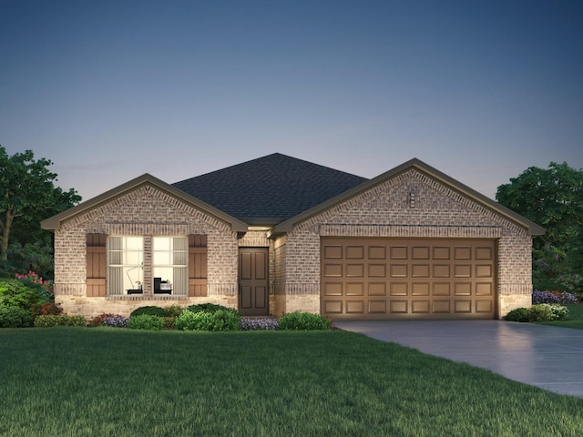 view of front facade with a garage and a lawn