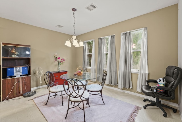 dining space with a chandelier