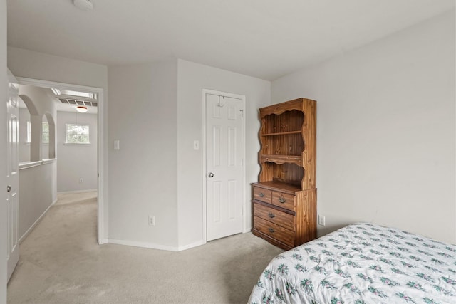 bedroom featuring light colored carpet and a closet