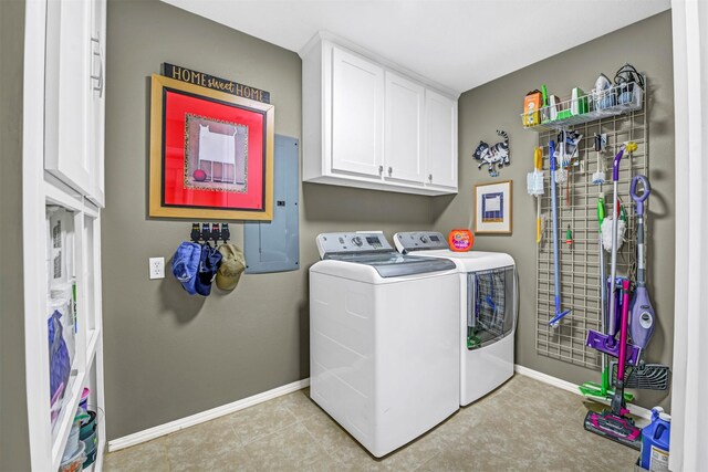 clothes washing area featuring washer and dryer, cabinets, and electric panel