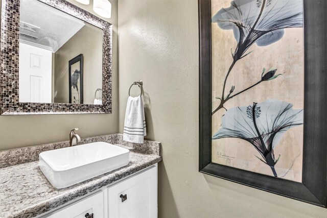 bathroom with vanity and a textured ceiling