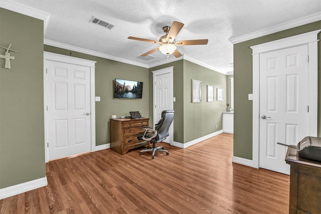 office area featuring ceiling fan, wood-type flooring, crown molding, and a textured ceiling