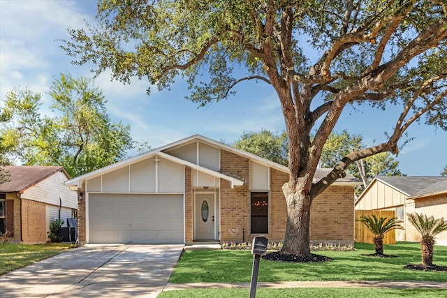 single story home featuring a garage and a front yard