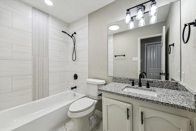 full bathroom with vanity, toilet, and tiled shower / bath