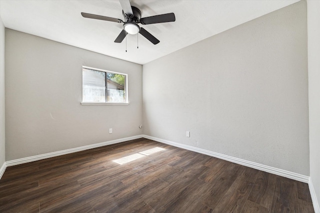 unfurnished room with ceiling fan and dark wood-type flooring