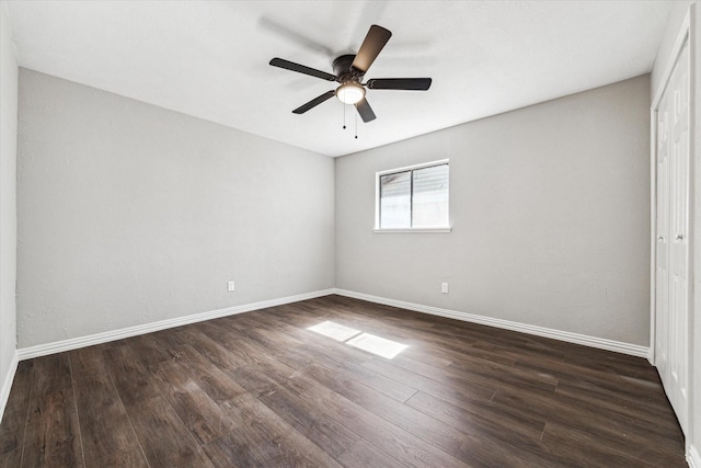 unfurnished room with ceiling fan and dark wood-type flooring