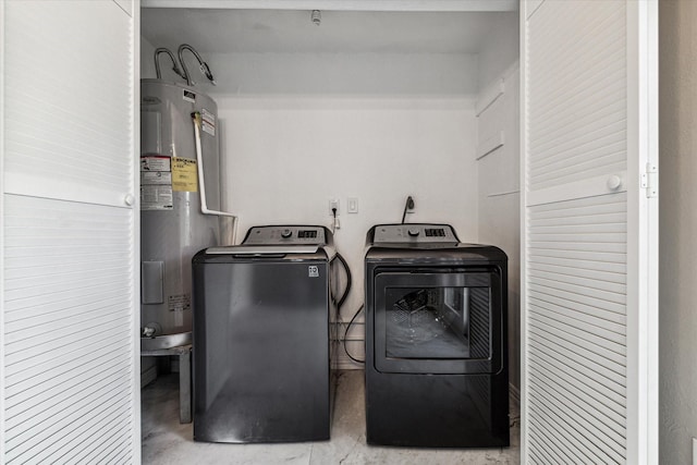 clothes washing area featuring separate washer and dryer and water heater