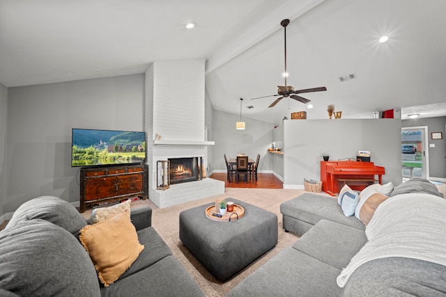 living room featuring hardwood / wood-style flooring, ceiling fan, a fireplace, and lofted ceiling with beams