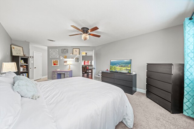 bedroom featuring ceiling fan and light carpet