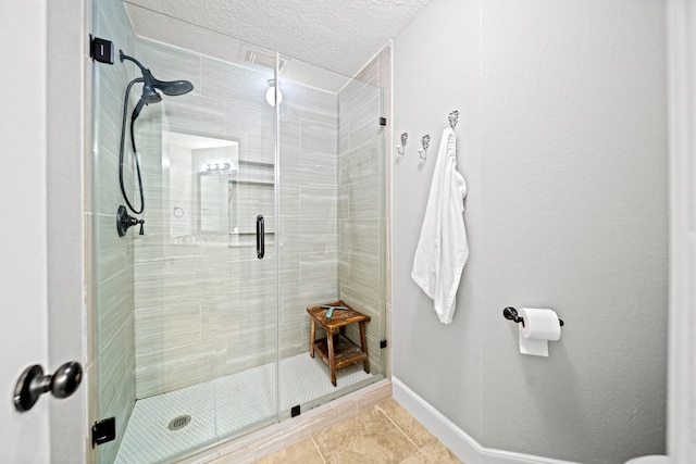 bathroom with tile patterned flooring, a textured ceiling, and walk in shower