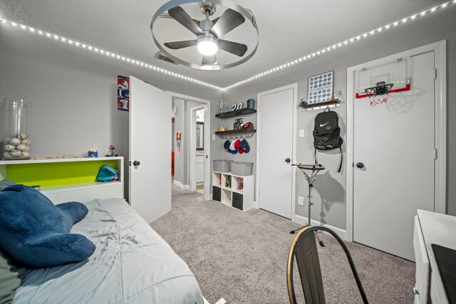 carpeted bedroom with ceiling fan