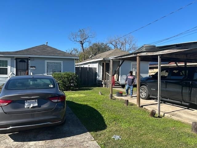 view of home's exterior with a yard and a carport