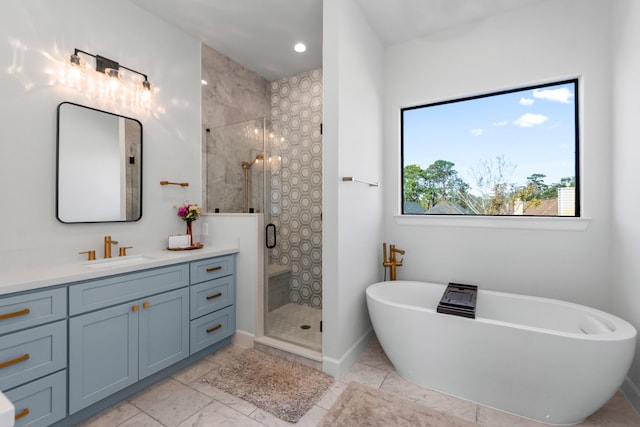 bathroom featuring vanity and separate shower and tub