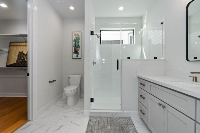 bathroom with vanity, an enclosed shower, and toilet