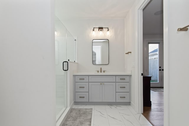 bathroom featuring vanity and a shower with shower door