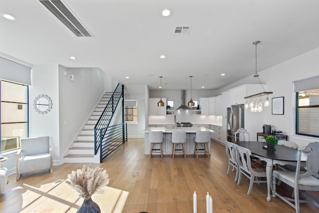 dining space with an inviting chandelier and light wood-type flooring