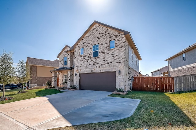 view of front of home featuring a front yard and a garage