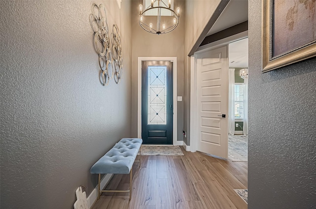 foyer featuring an inviting chandelier and light wood-type flooring