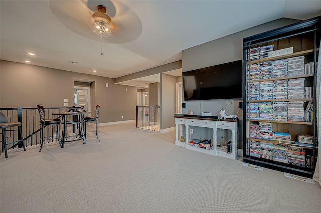 carpeted living room featuring ceiling fan and lofted ceiling