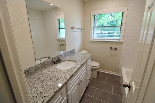 bathroom featuring tile patterned flooring, vanity, and toilet