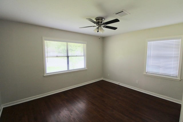 spare room with ceiling fan and dark hardwood / wood-style flooring