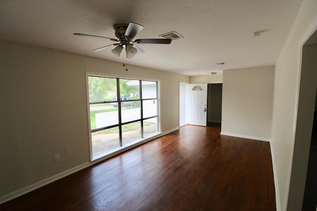 empty room featuring dark hardwood / wood-style flooring and ceiling fan