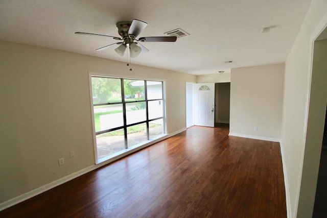 unfurnished room with dark hardwood / wood-style floors and ceiling fan