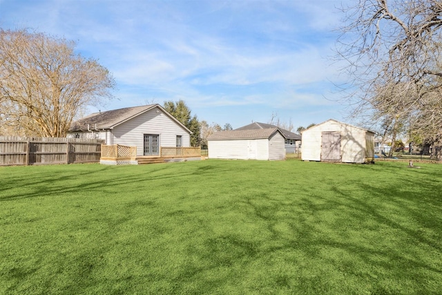 view of yard with a storage unit and a deck