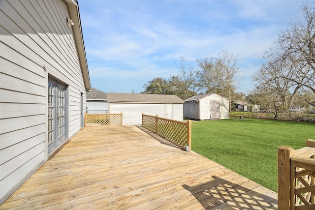 wooden deck with a storage unit and a lawn