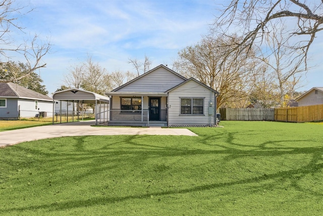 rear view of property with a yard and a carport