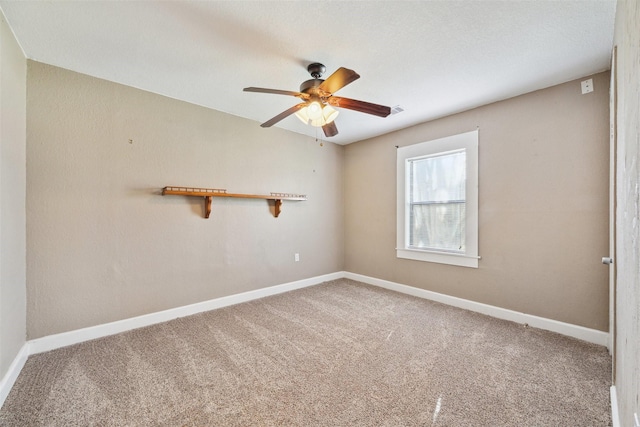 carpeted spare room with ceiling fan