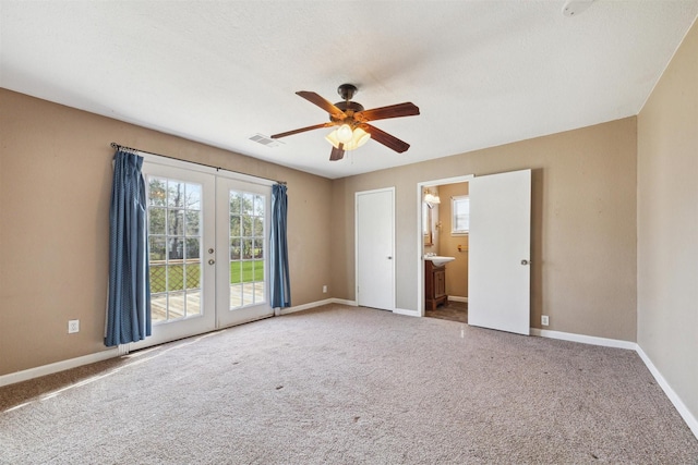 carpeted empty room with ceiling fan and french doors