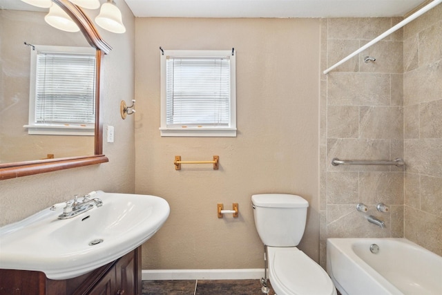 full bathroom featuring tile patterned flooring, vanity, toilet, and tiled shower / bath