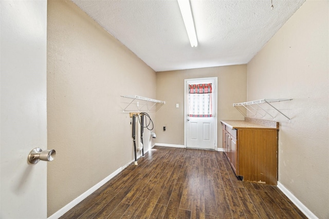 laundry room with a textured ceiling, dark wood-type flooring, and washer hookup