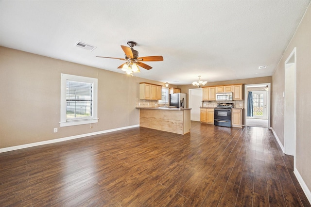 unfurnished living room with dark wood-type flooring and ceiling fan with notable chandelier