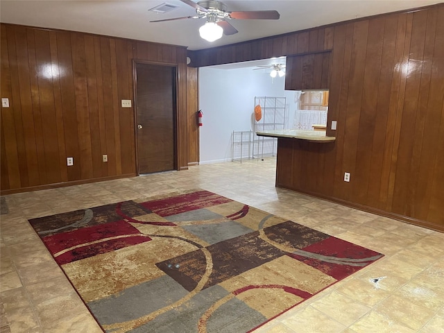 kitchen with wood walls and ceiling fan