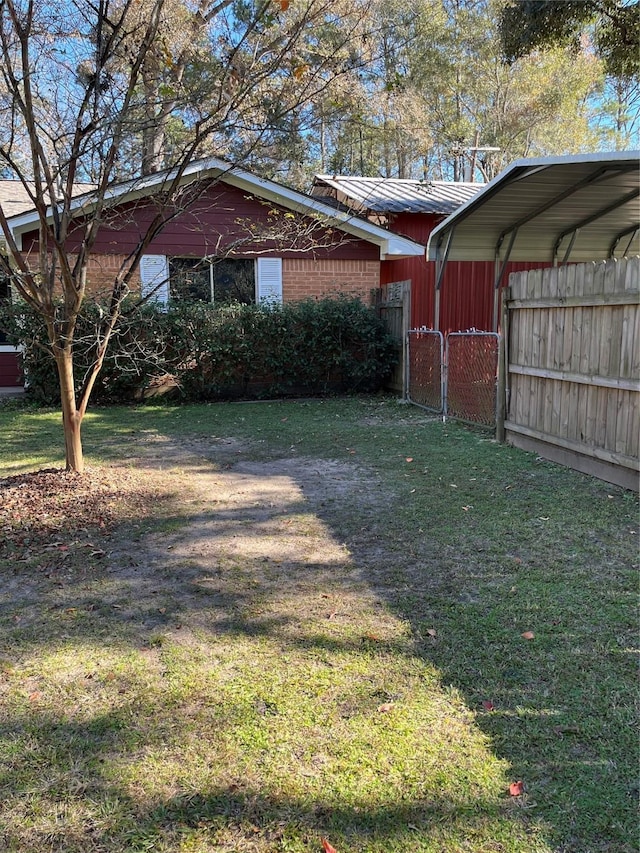 exterior space with a yard and a carport