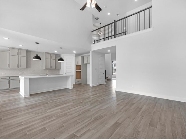 3248 Stingray Cove Dr, Katy, TX 77493 - unfurnished living room featuring a sink, recessed lighting, ceiling fan, light wood finished floors, and baseboards