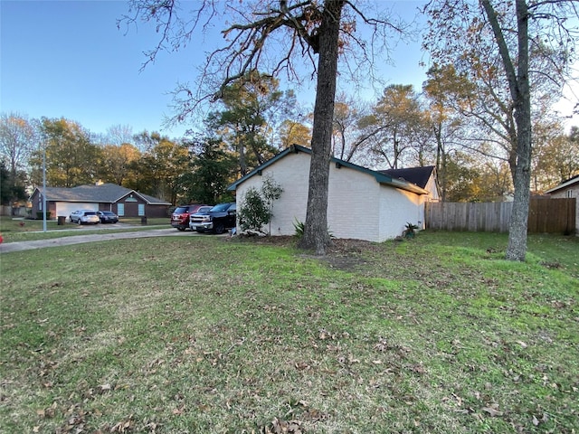 view of side of property with a lawn