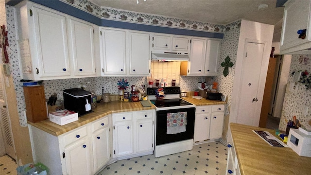 kitchen featuring white cabinets, decorative backsplash, and white electric stove