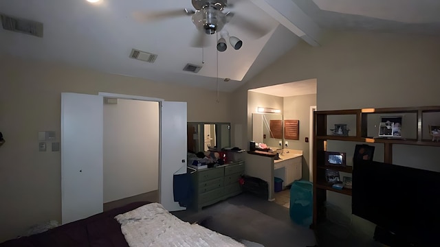 bedroom featuring vaulted ceiling with beams and ensuite bathroom