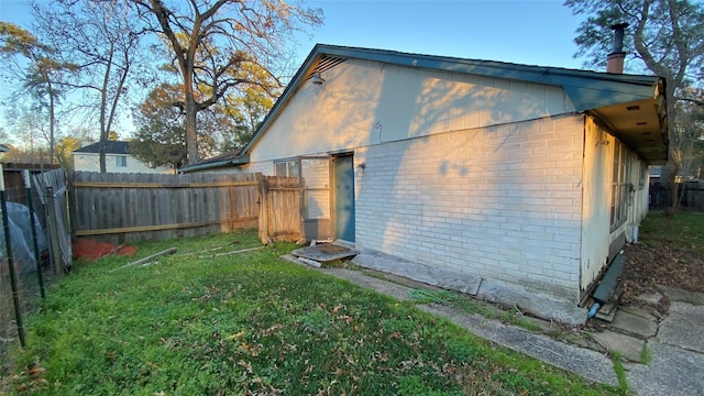 rear view of house featuring a lawn