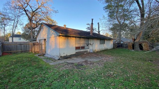 rear view of house featuring a yard