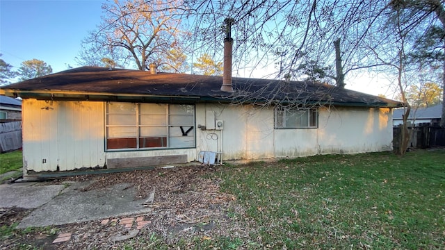 back of property featuring a yard